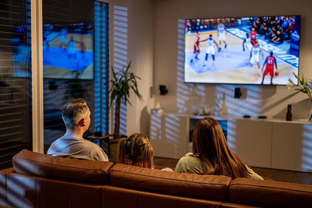 Happy family enjoying GOT ONE TV+ content together in their living room